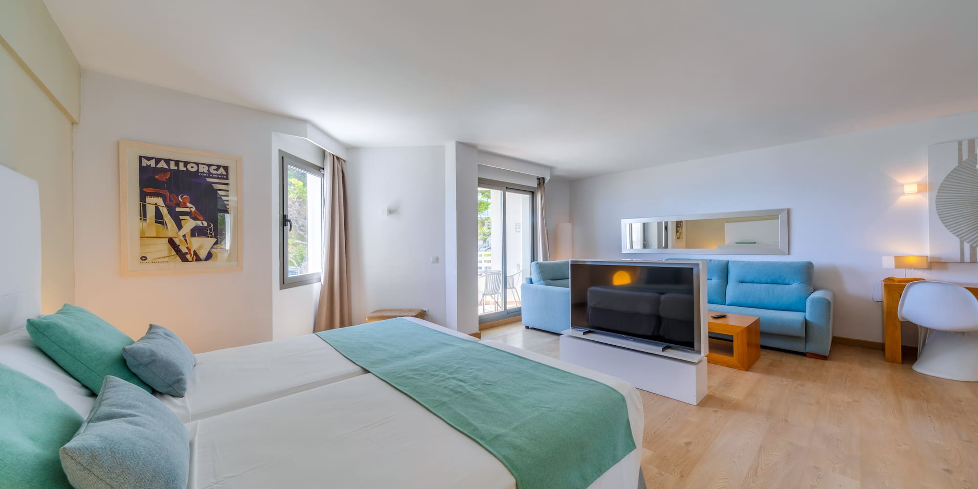 a room with two beds and a television