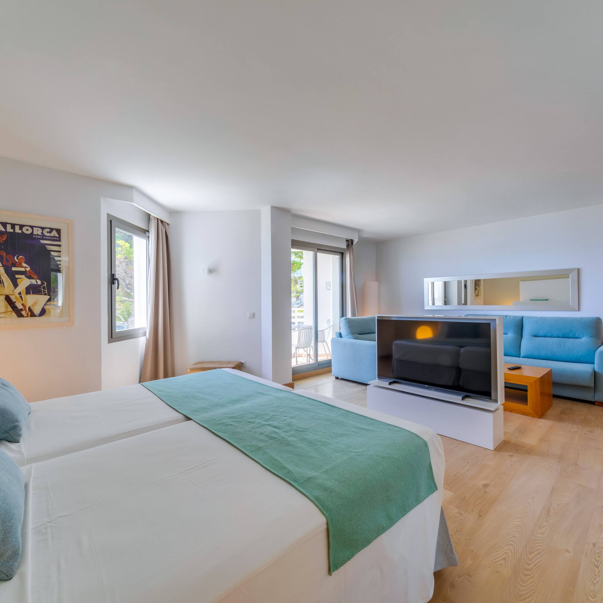 a room with two beds and a television