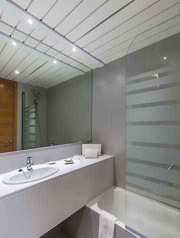 a bathroom with a shower and sink