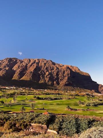 a golf course with a mountain in the background