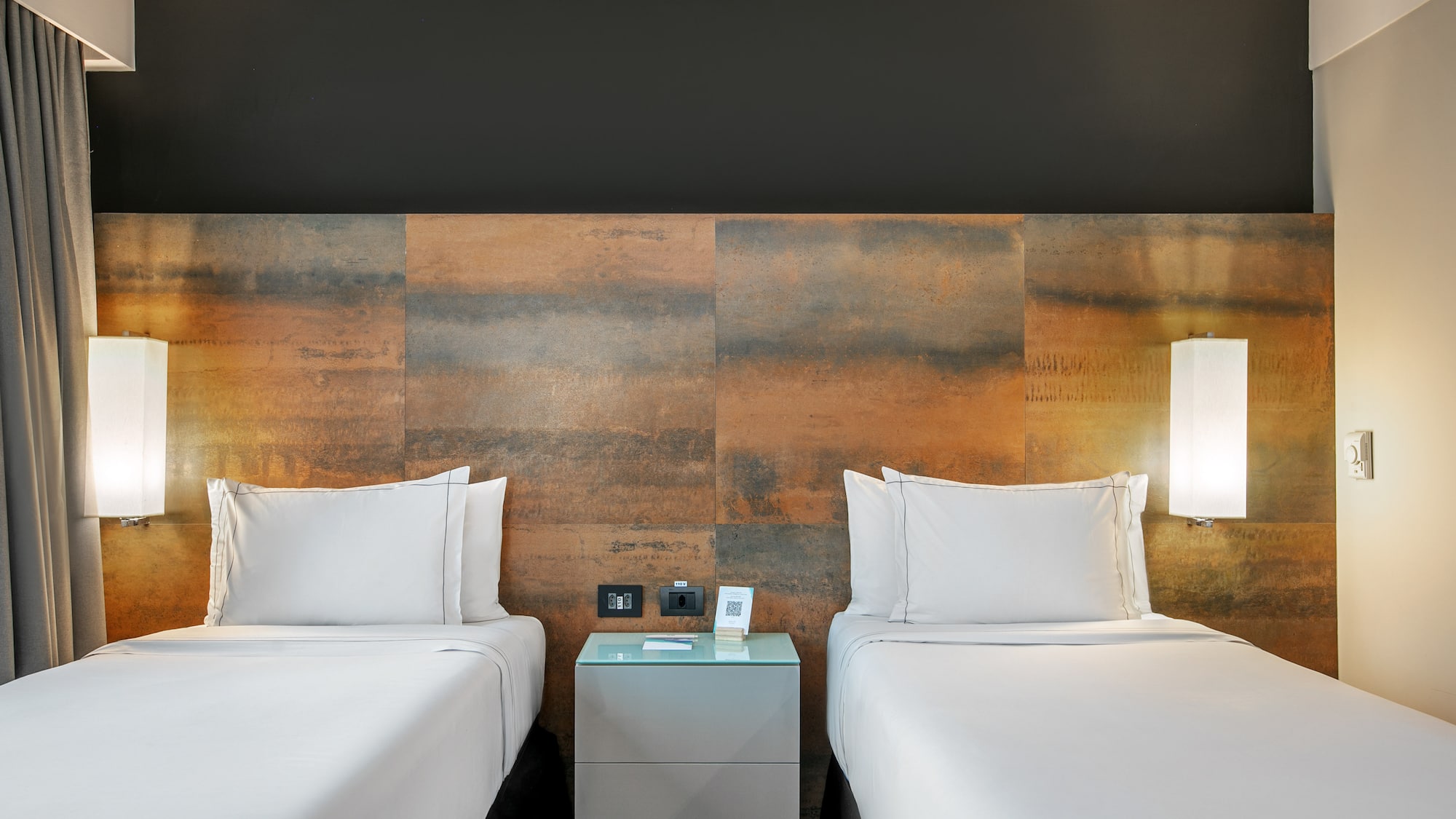 Quarto de hotel moderno com duas camas de solteiro e cabeceira de metal oxidado. - Deluxe Room Twin - Meliá Ibirapuera, São Paulo
