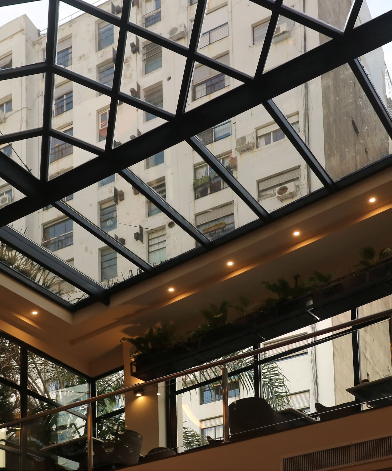 a glass roof with a building in the background