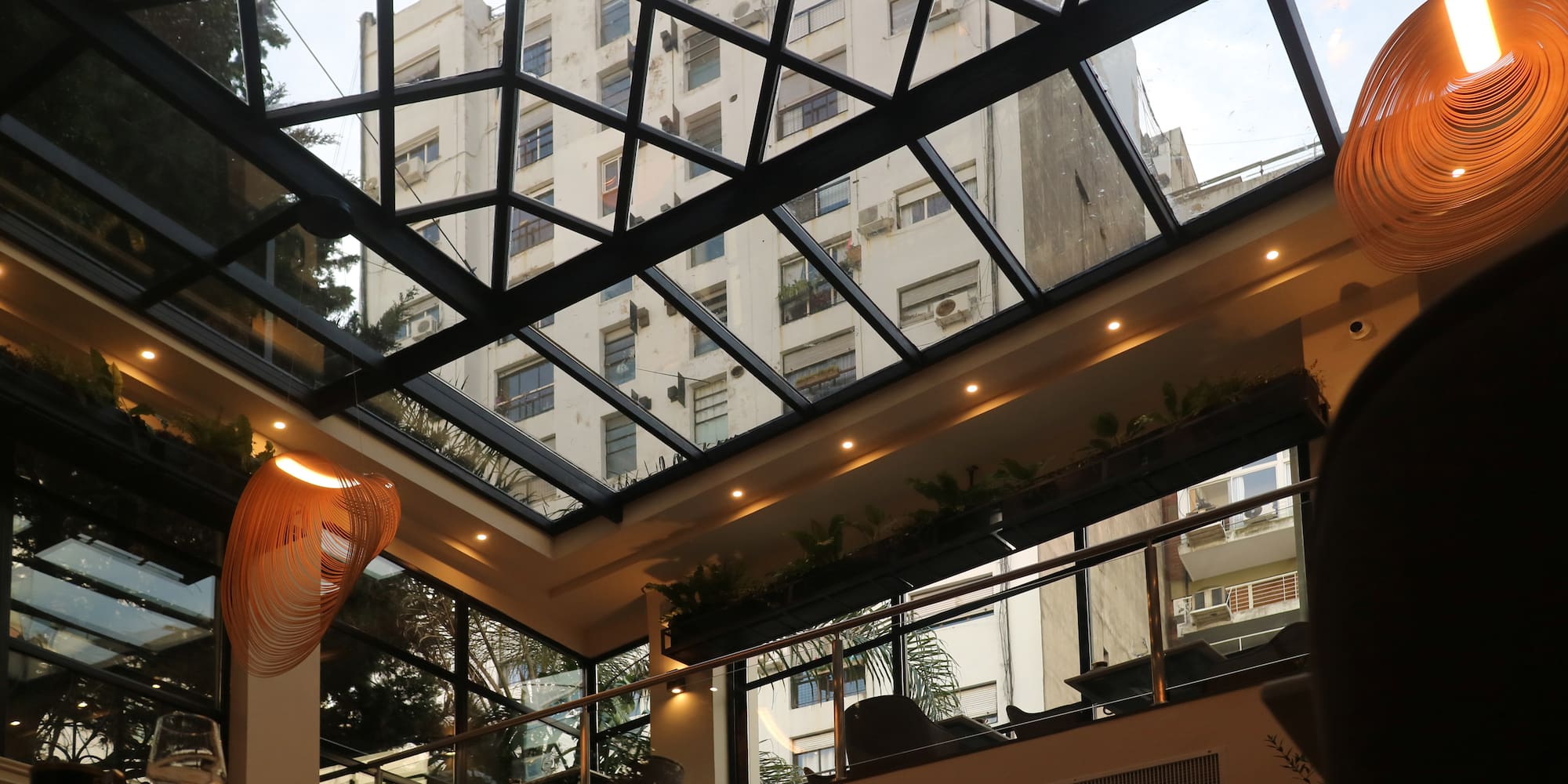 a glass roof with a building in the background