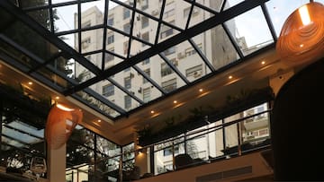 a glass roof with a building in the background