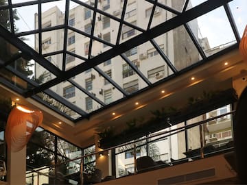 a glass roof with a building in the background