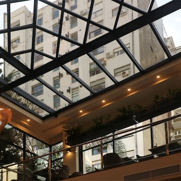 a glass roof with a building in the background