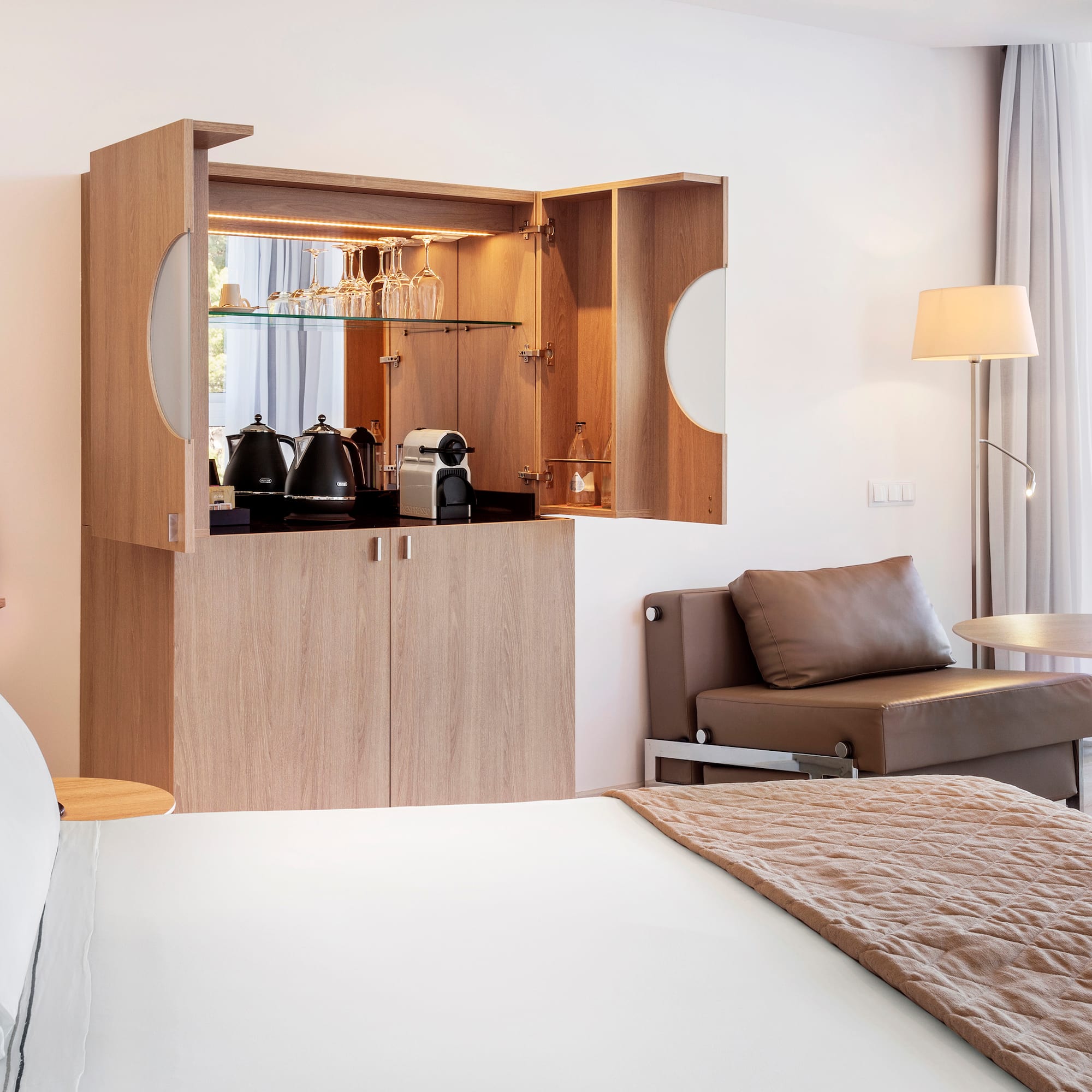 a room with a bed and a coffee maker