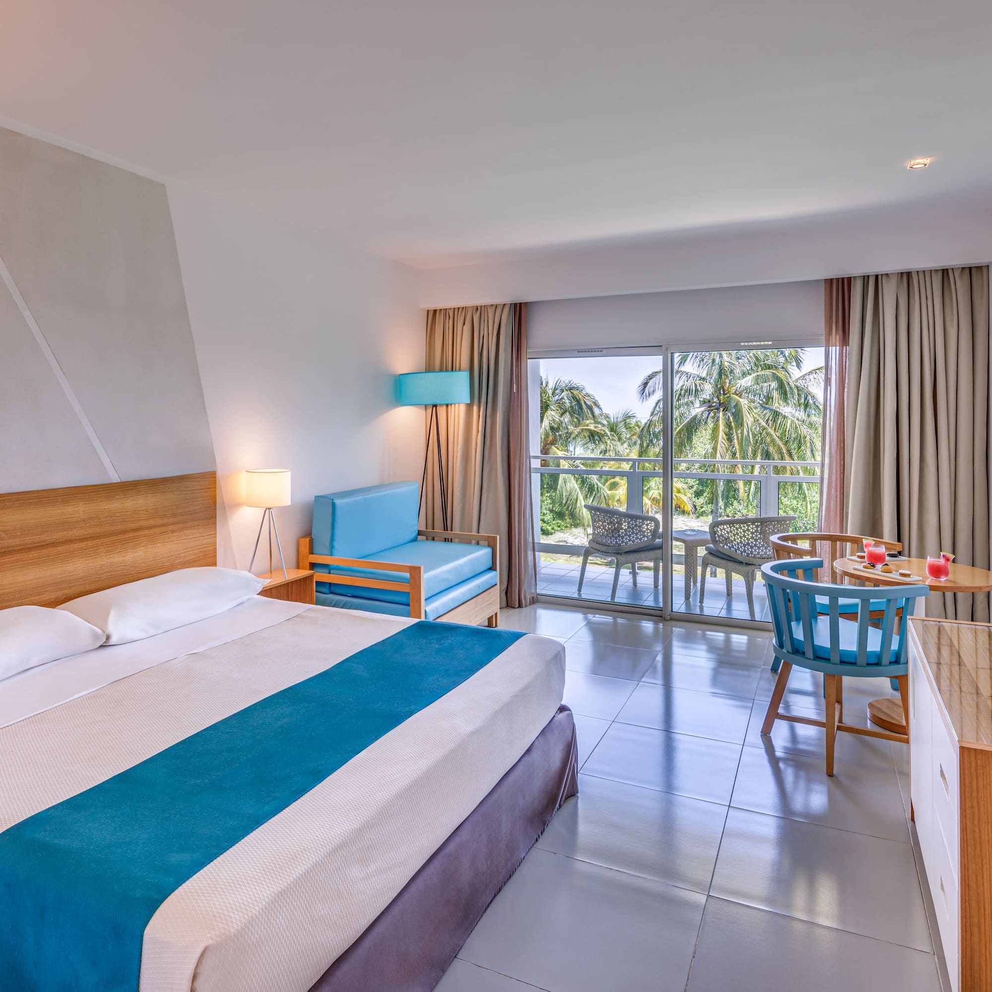 a room with a bed and a table and chairs