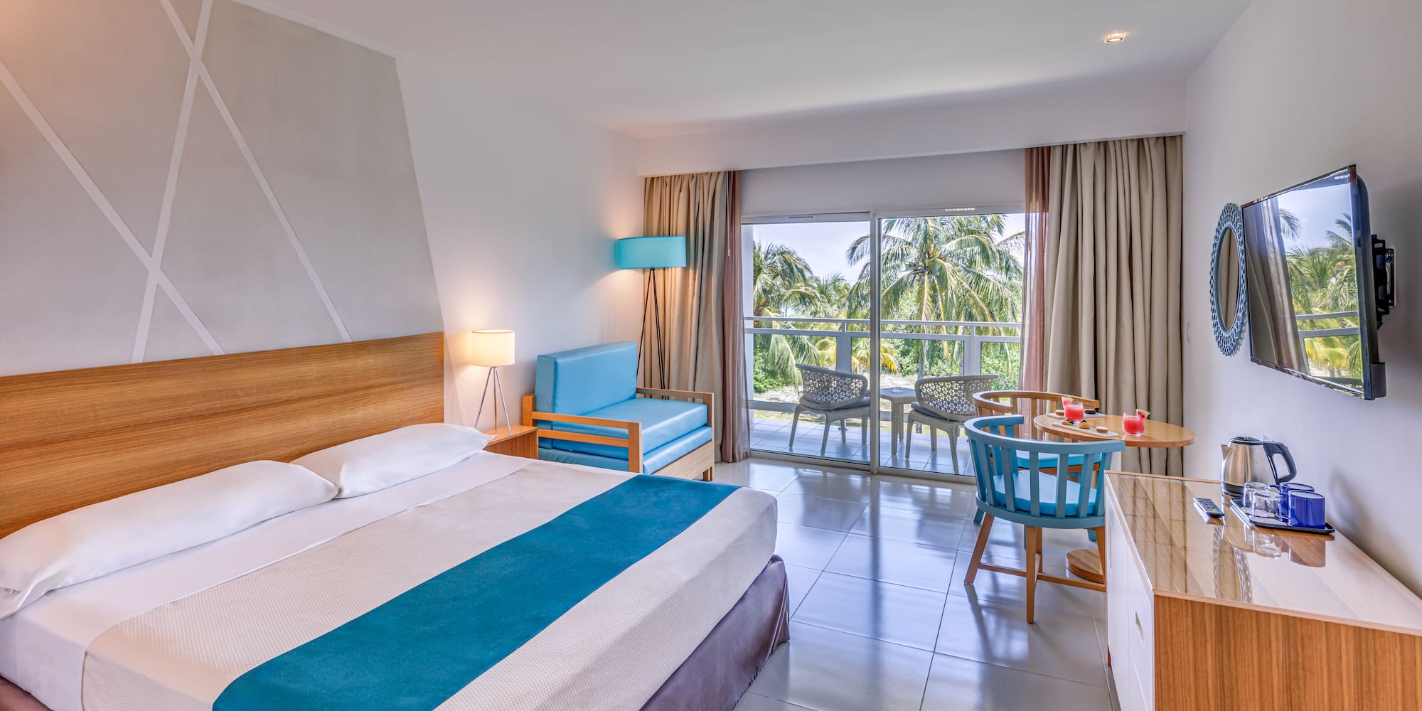 a room with a bed and a table and chairs