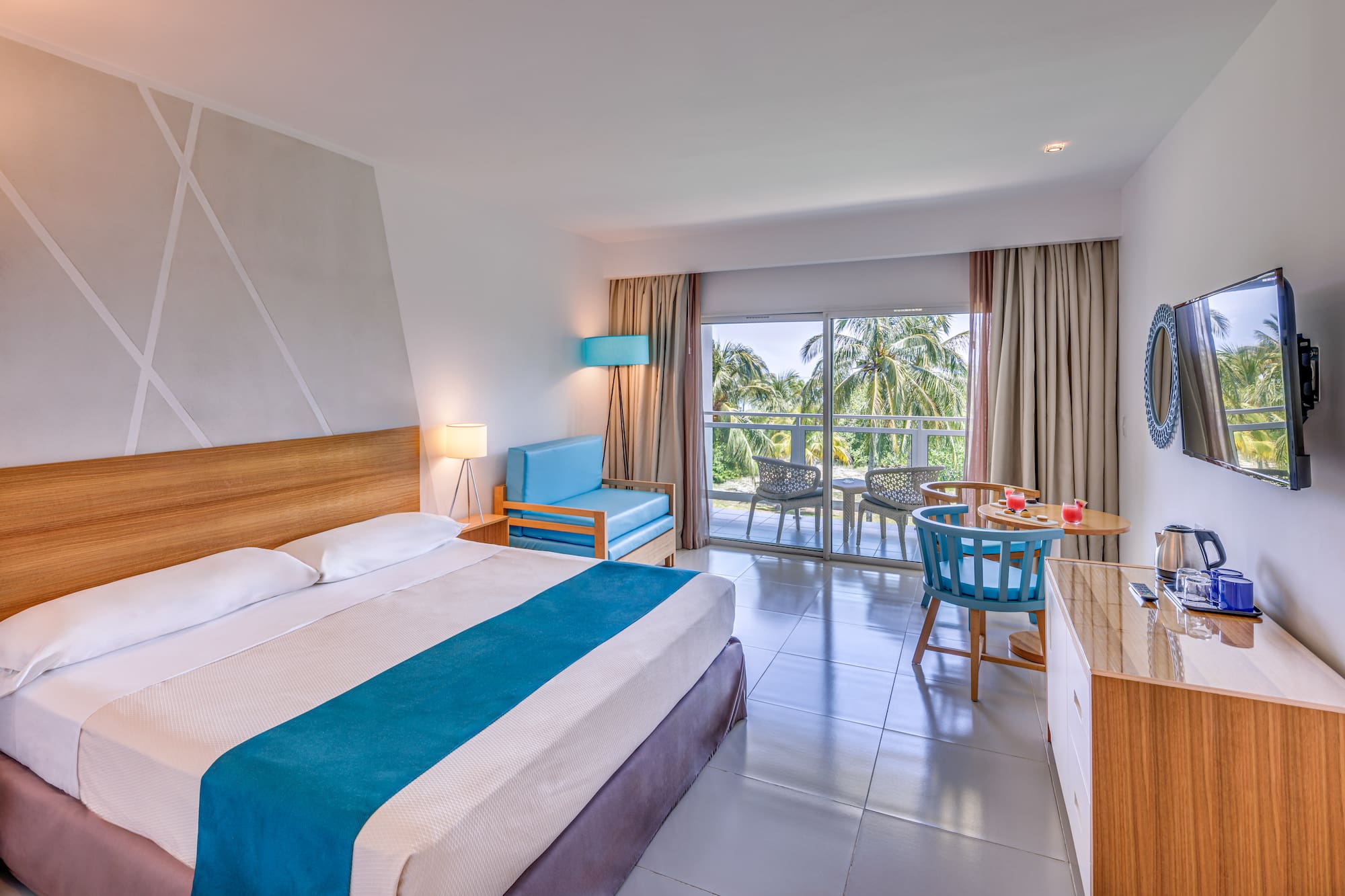 a room with a bed and a table and chairs