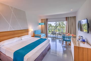 a room with a bed and a table and chairs