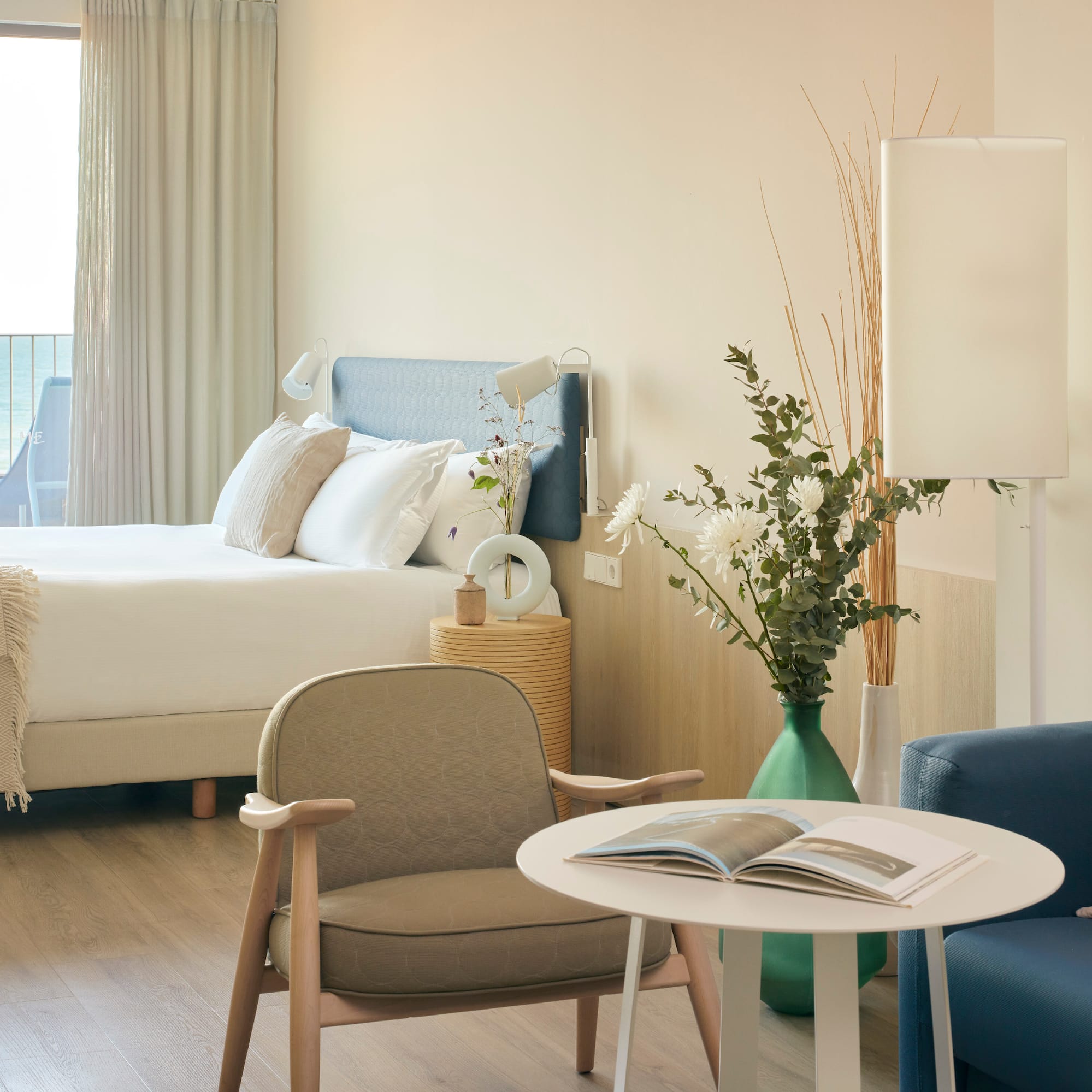 a room with a bed and a table and chairs