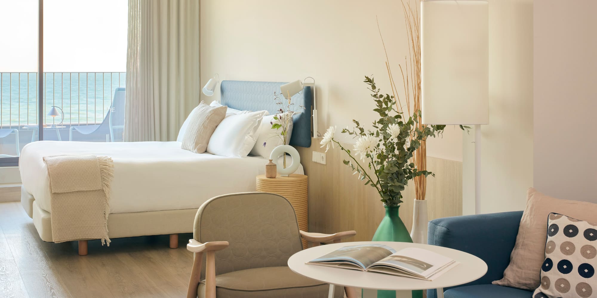 a room with a bed and a table and chairs