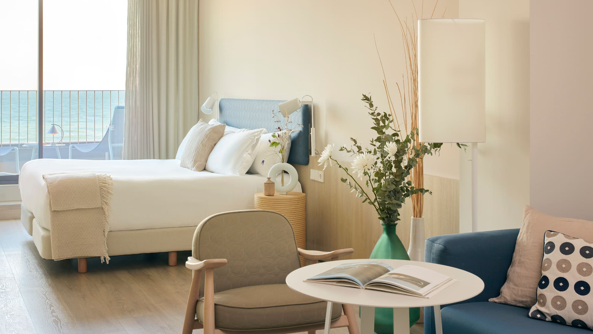 a room with a bed and a table and chairs