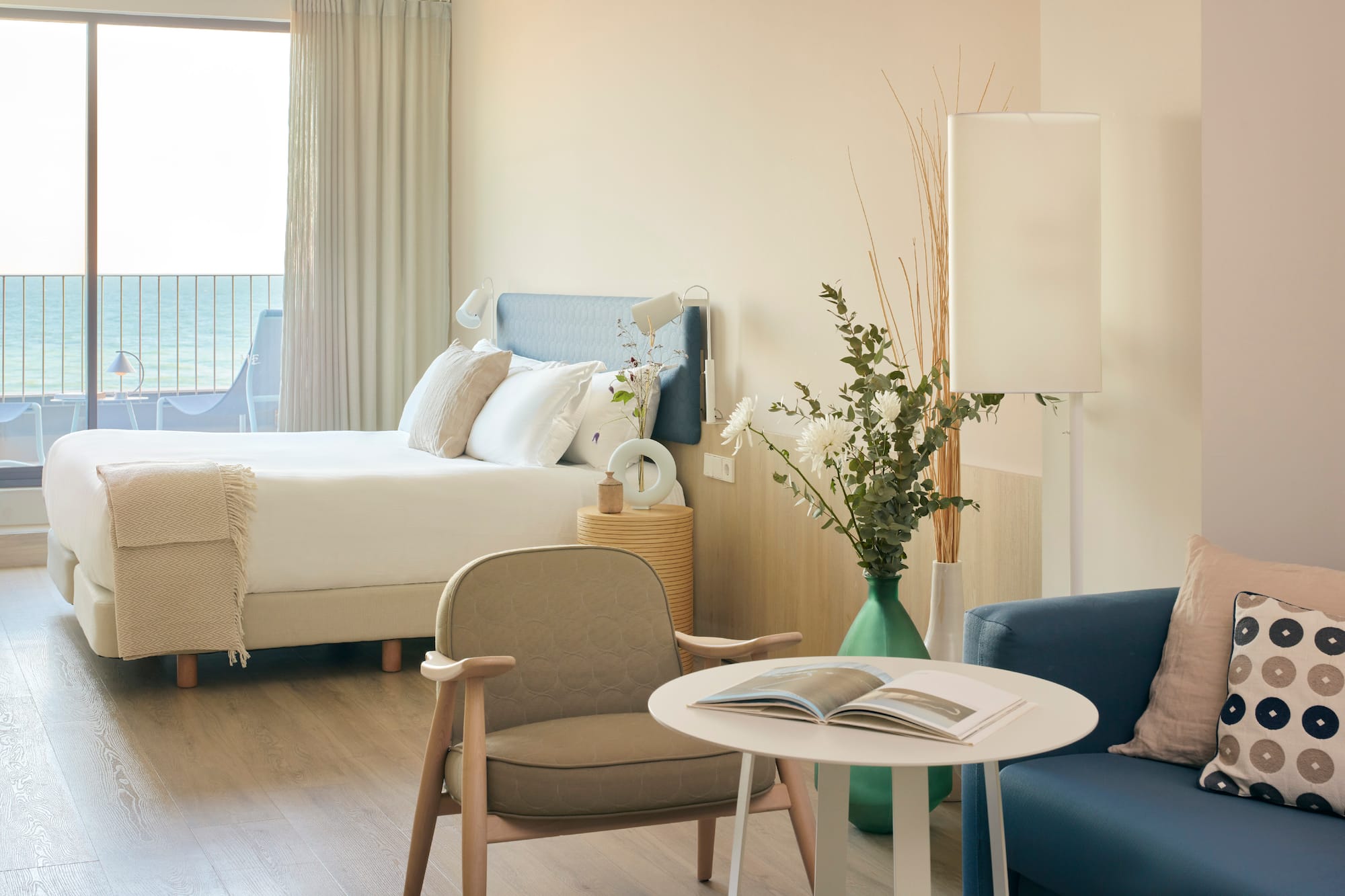 a room with a bed and a table and chairs