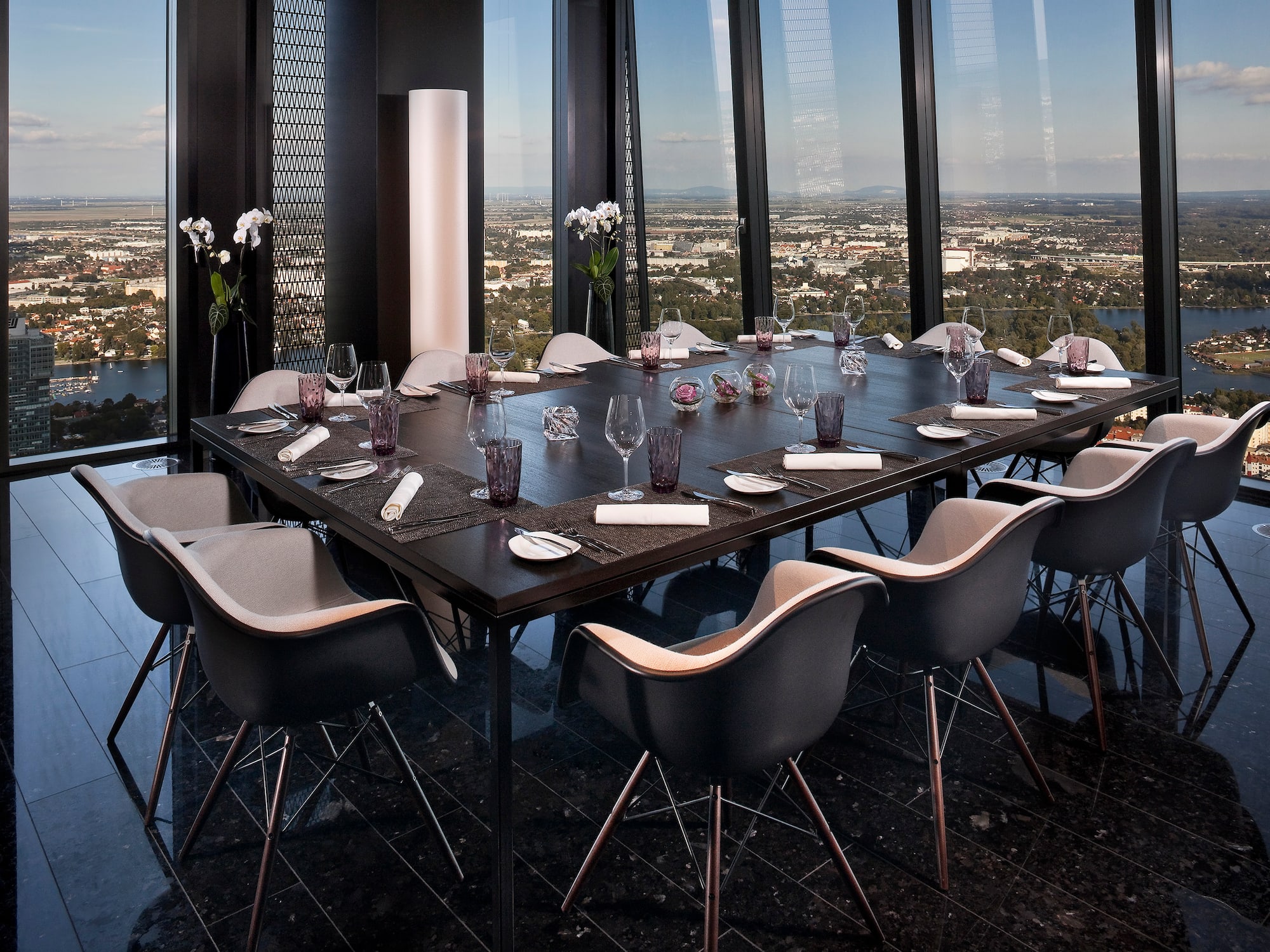 a table with chairs and glasses on it