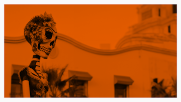 a skeleton with flowers in front of a building