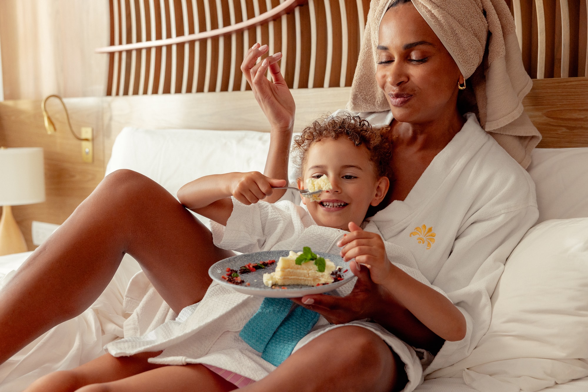 a woman and child eating cake