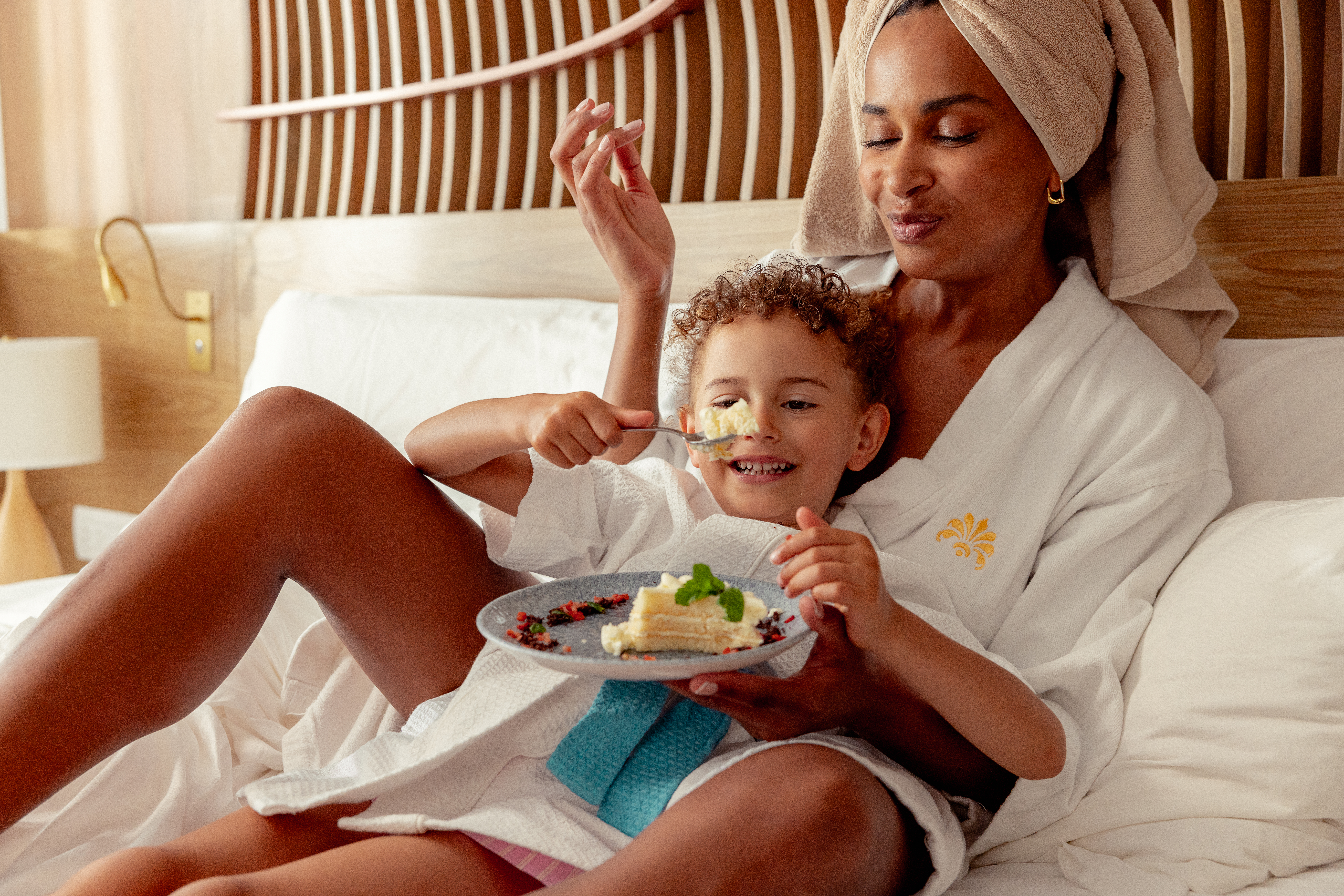 a woman and child eating cake