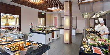 a buffet room with a person behind it