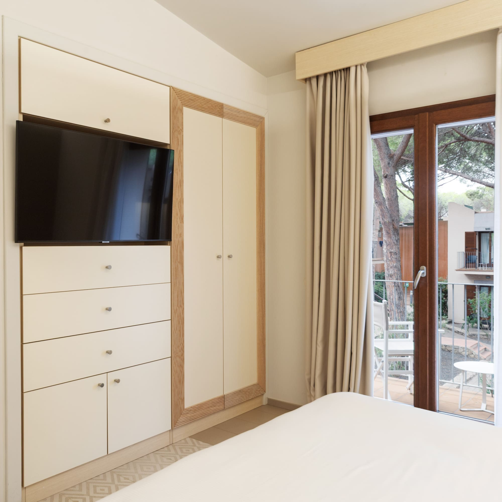 a bedroom with a television and a sliding glass door