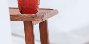 a glass of red liquid on a table