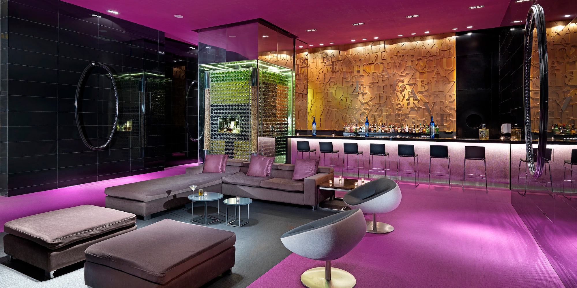 a room with purple walls and a bar