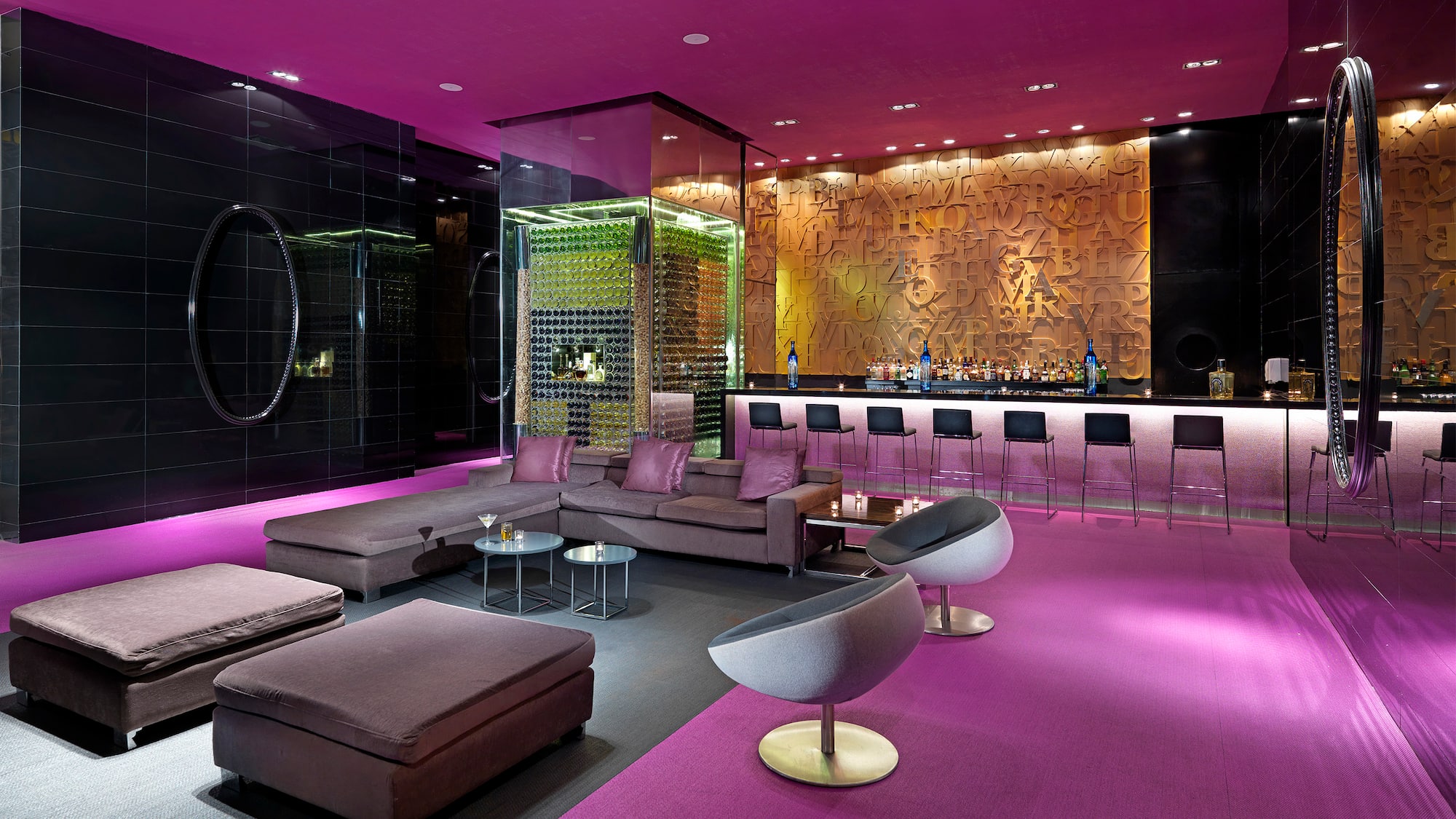a room with purple walls and a bar