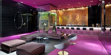 a room with purple walls and a bar