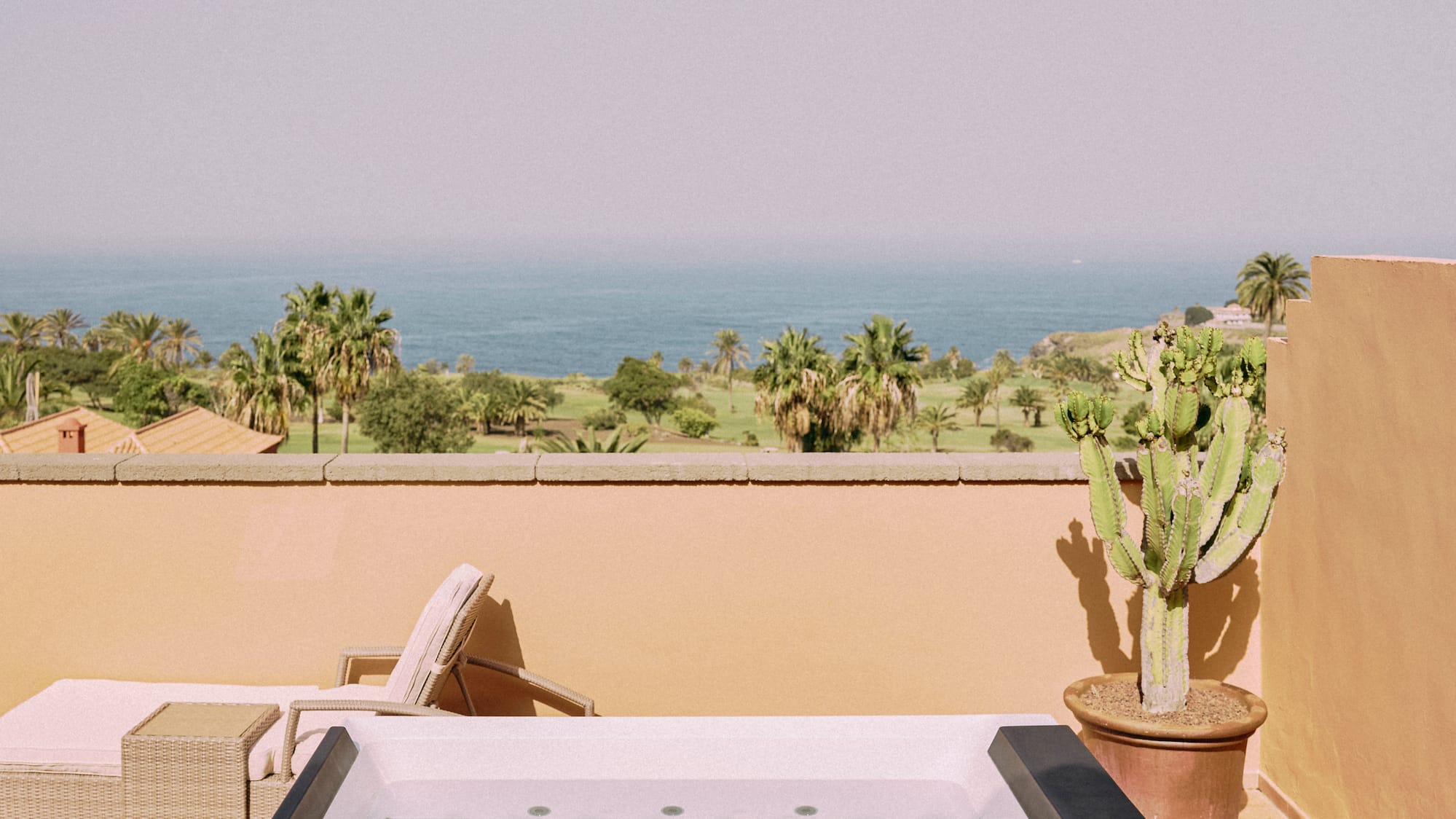 a hot tub on a deck overlooking a body of water