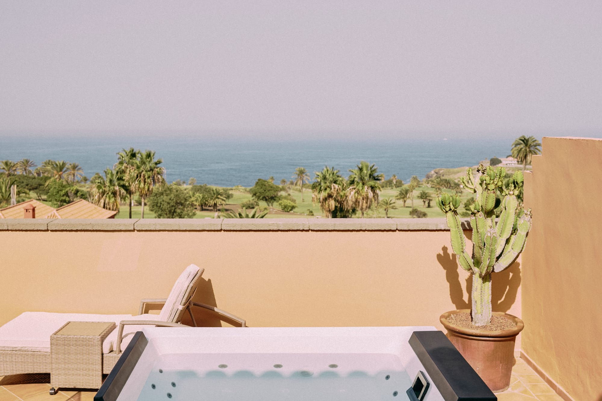 a hot tub on a deck overlooking a body of water