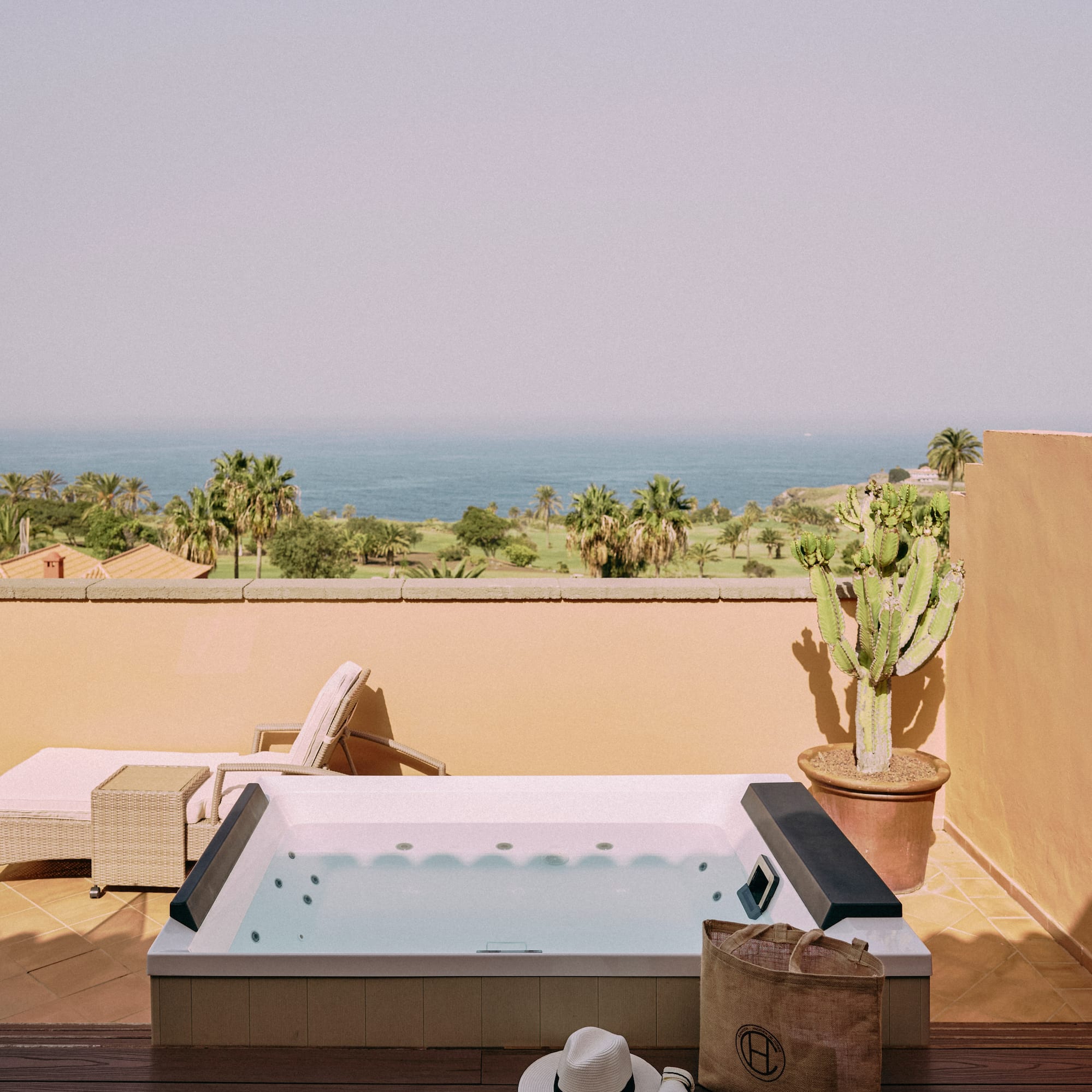a hot tub on a deck overlooking a body of water