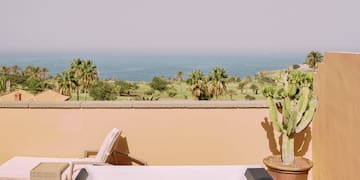 a hot tub on a deck overlooking a body of water