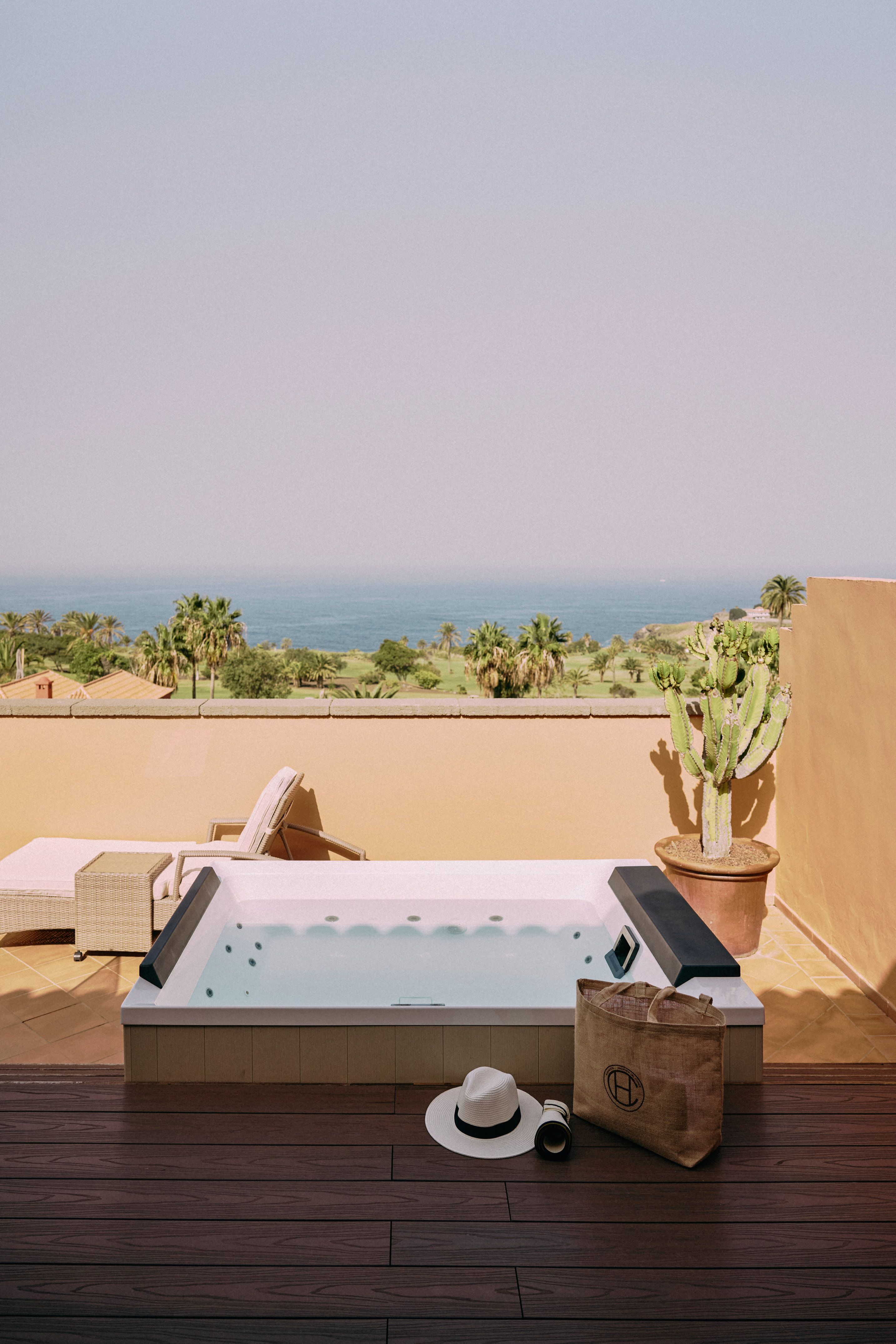 a hot tub on a deck overlooking a body of water