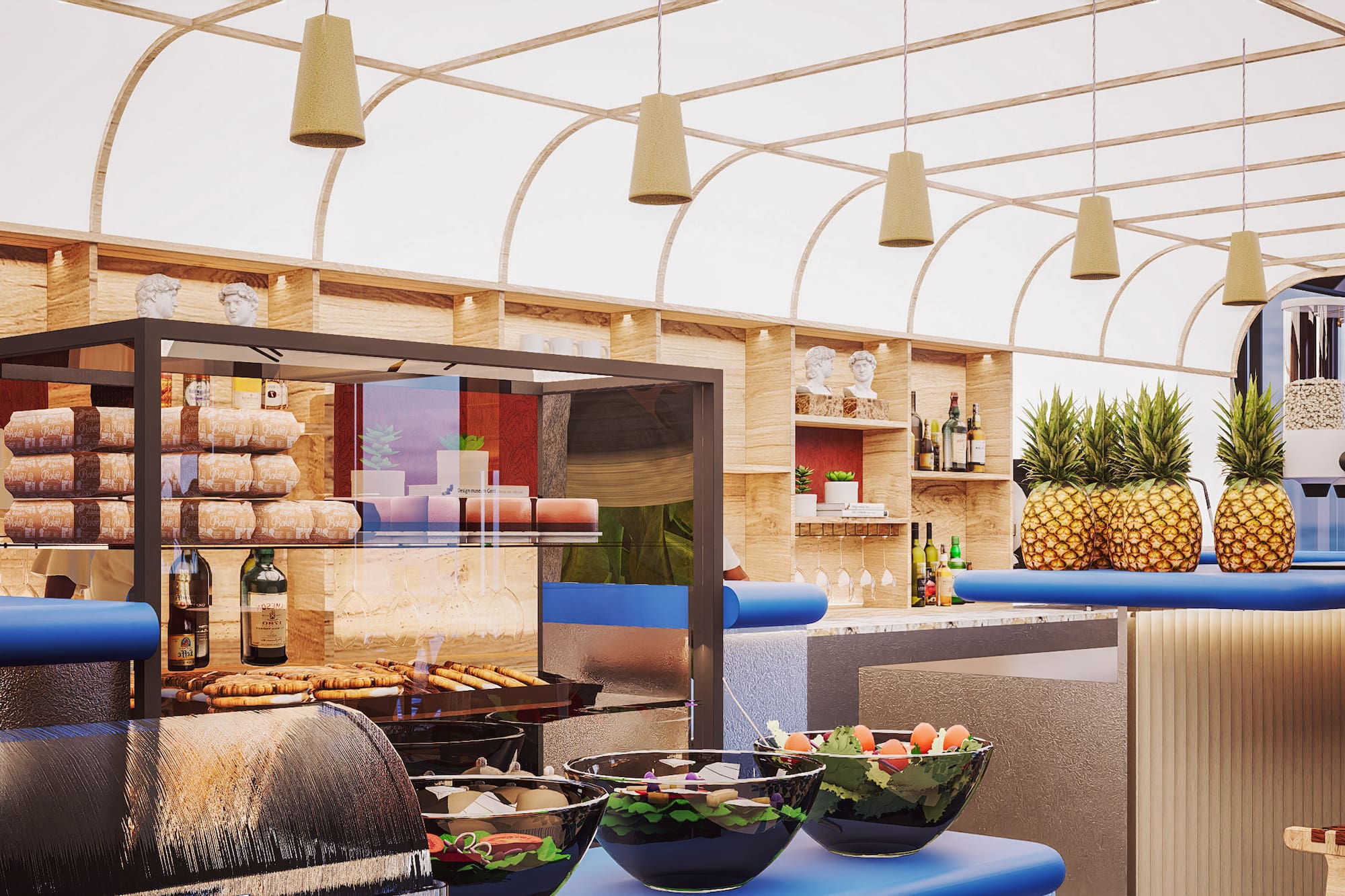 Hotel buffet bar with fresh pineapples, pastries, salads, and modern design.