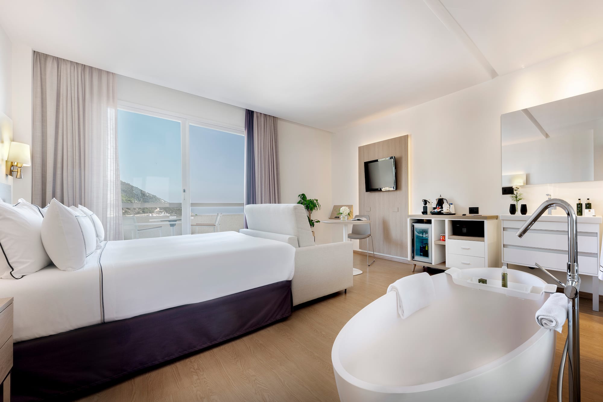 a room with a bed and a tub