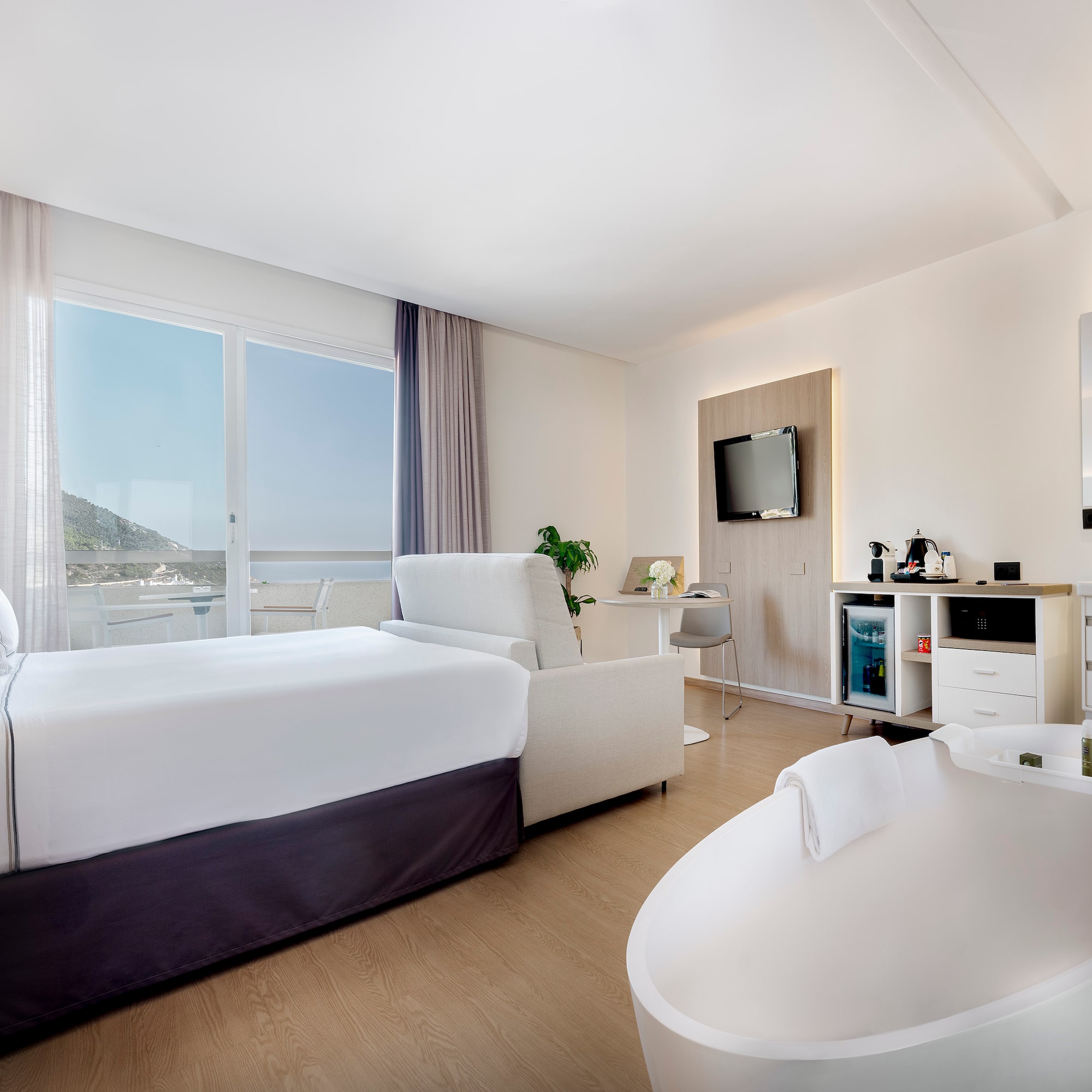 a room with a bed and a tub