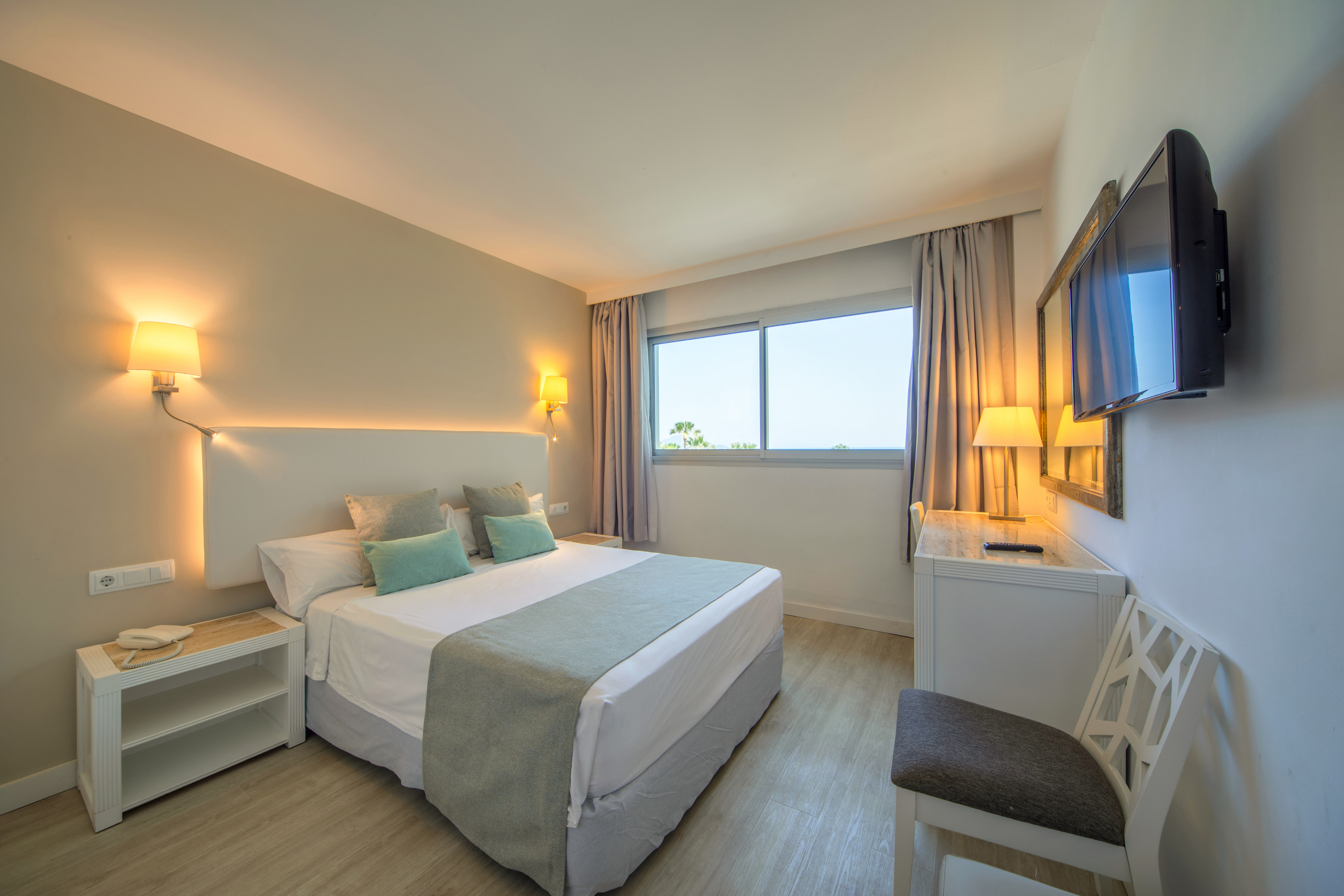 a bedroom with a bed and a table