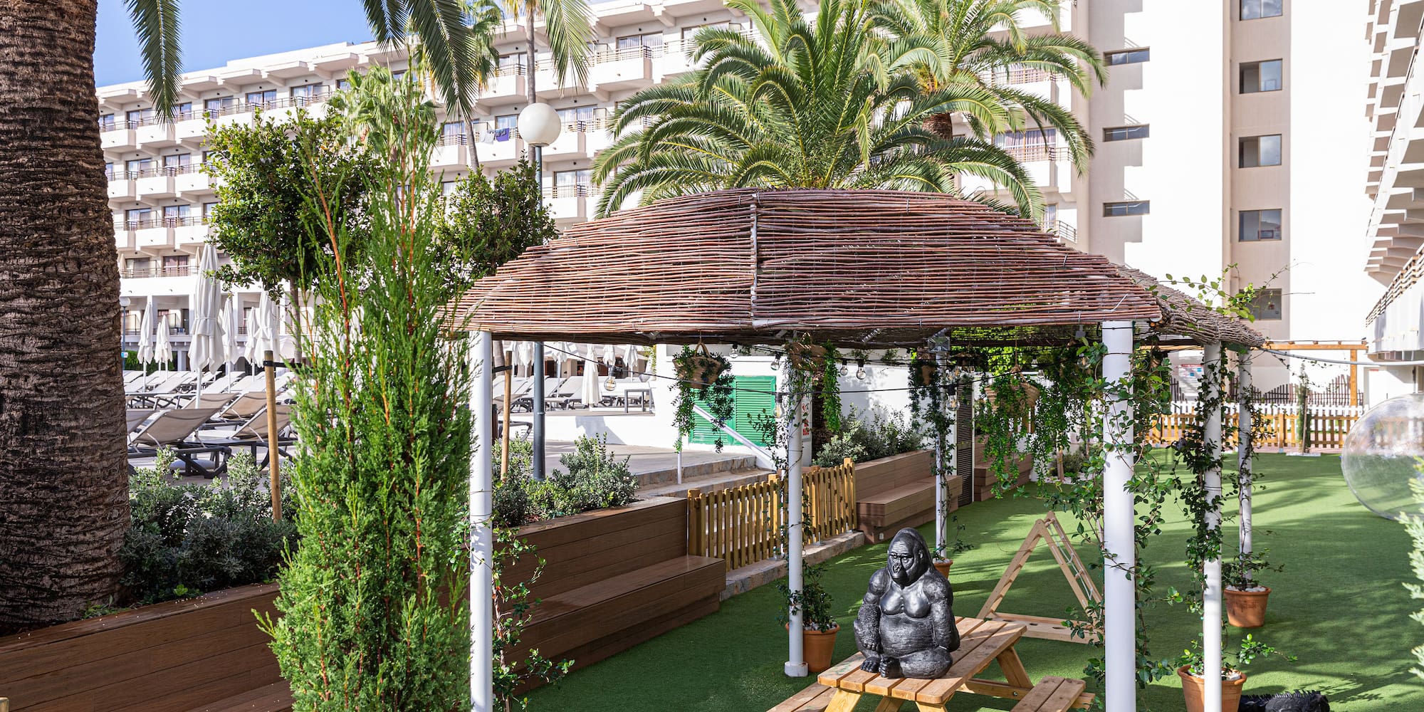 a wooden bench and a gazebo in a courtyard