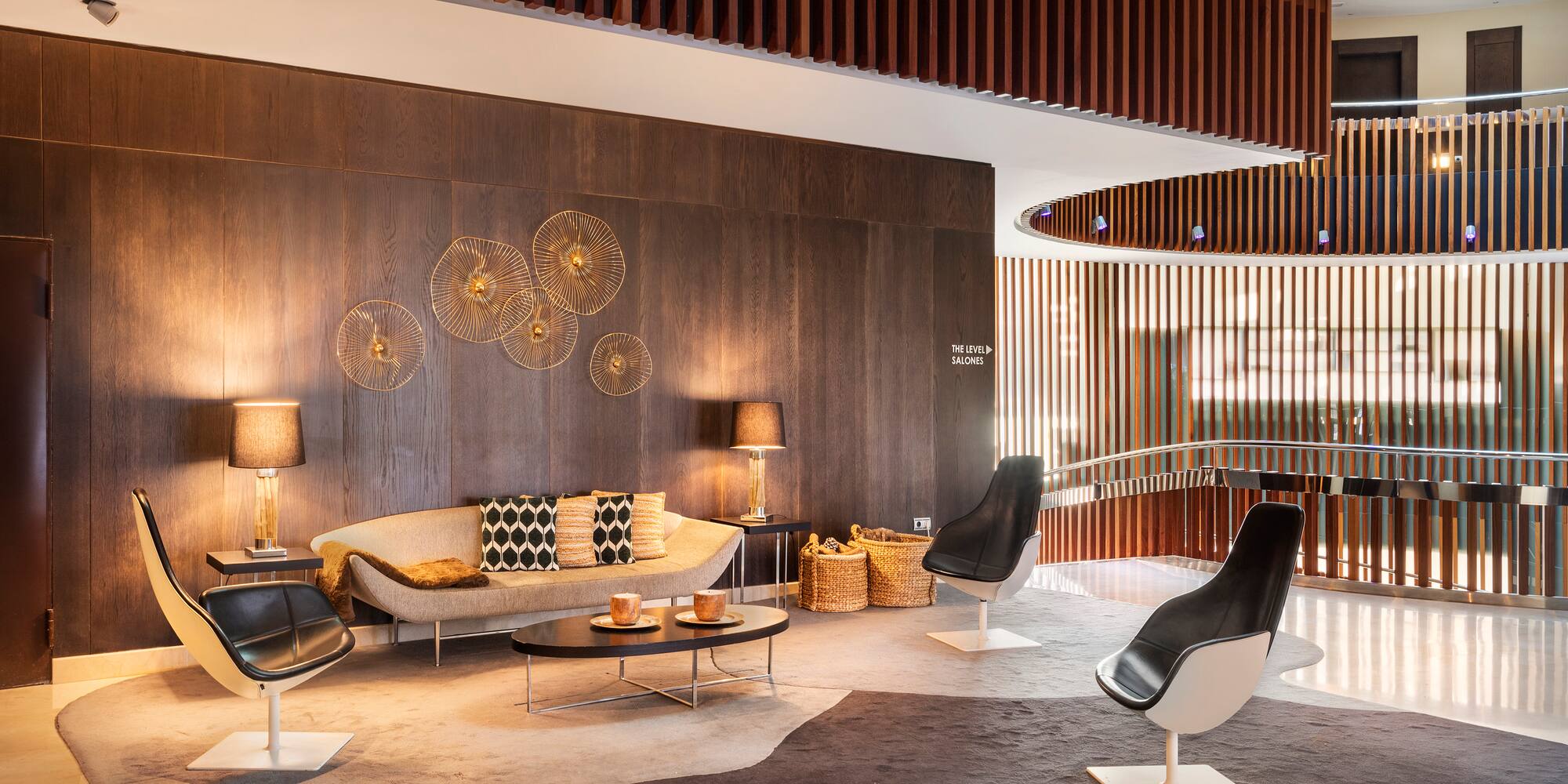a room with a couch and chairs