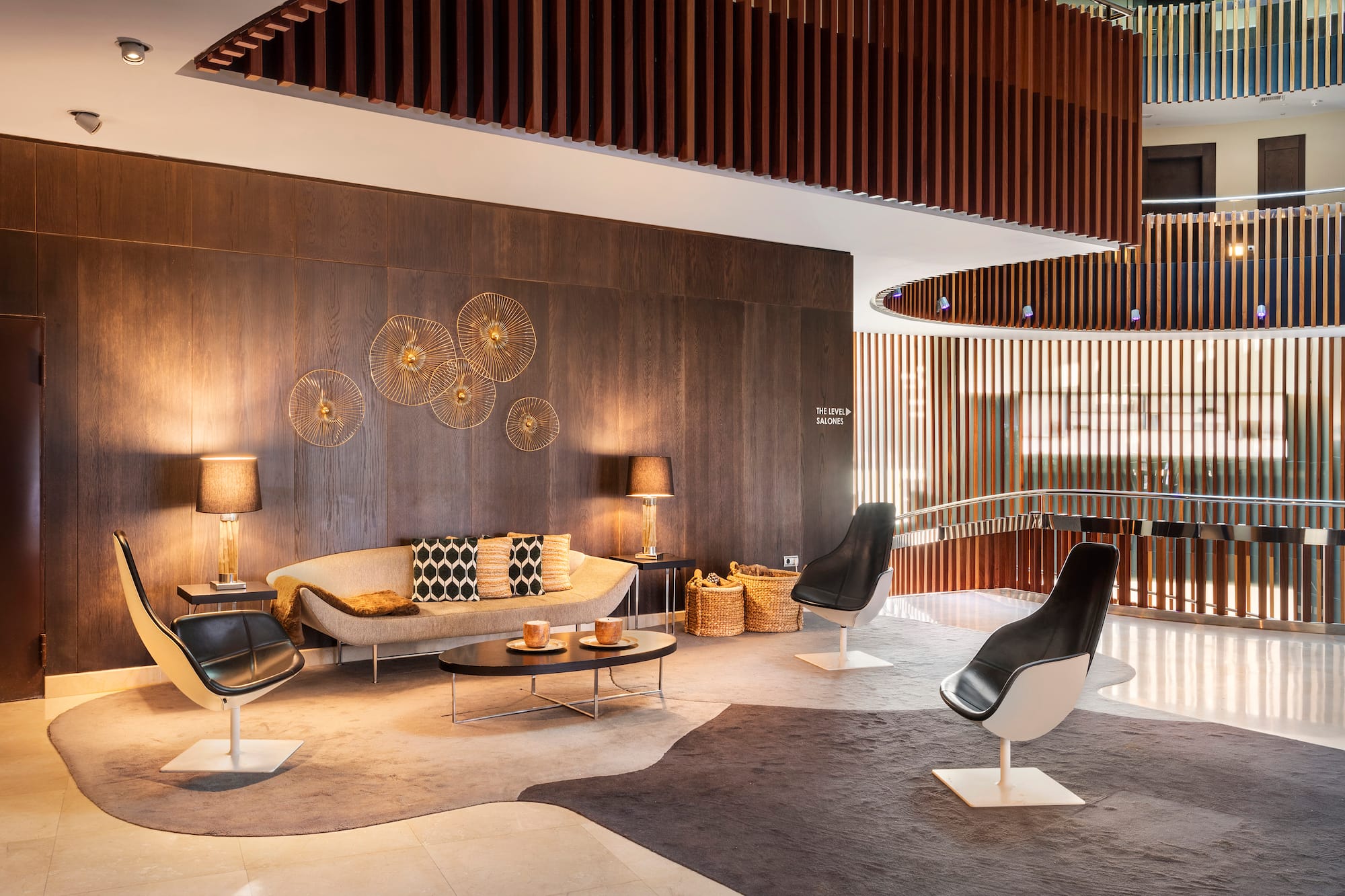 a room with a couch and chairs