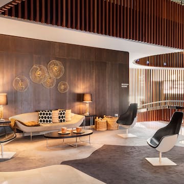 a room with a couch and chairs