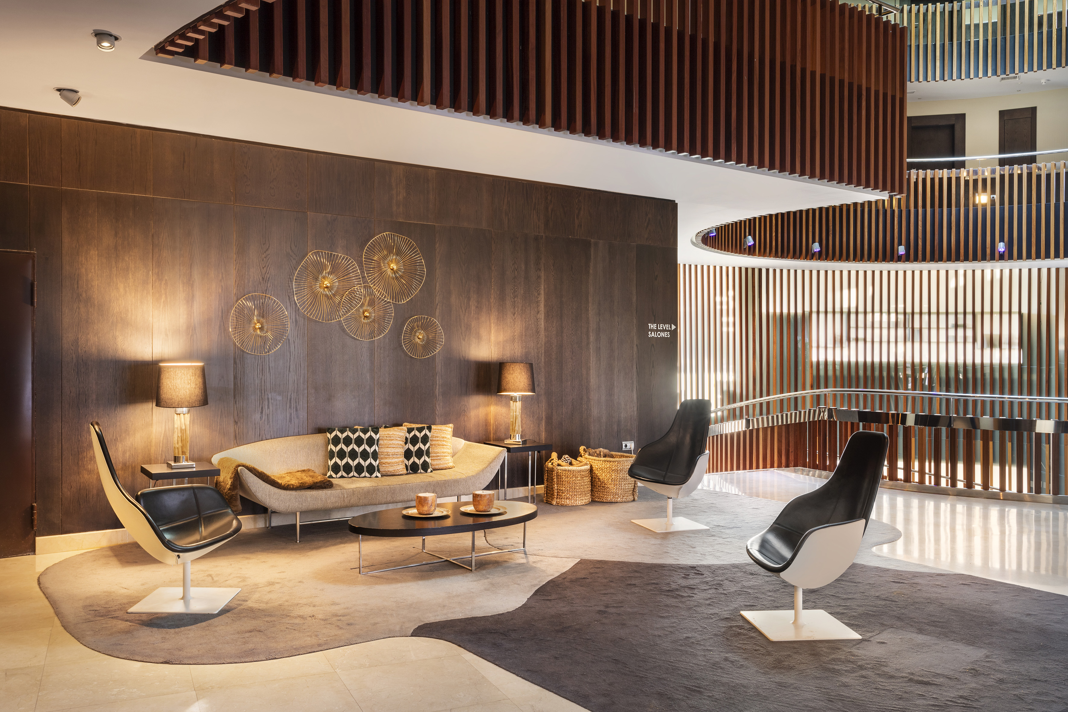 a room with a couch and chairs