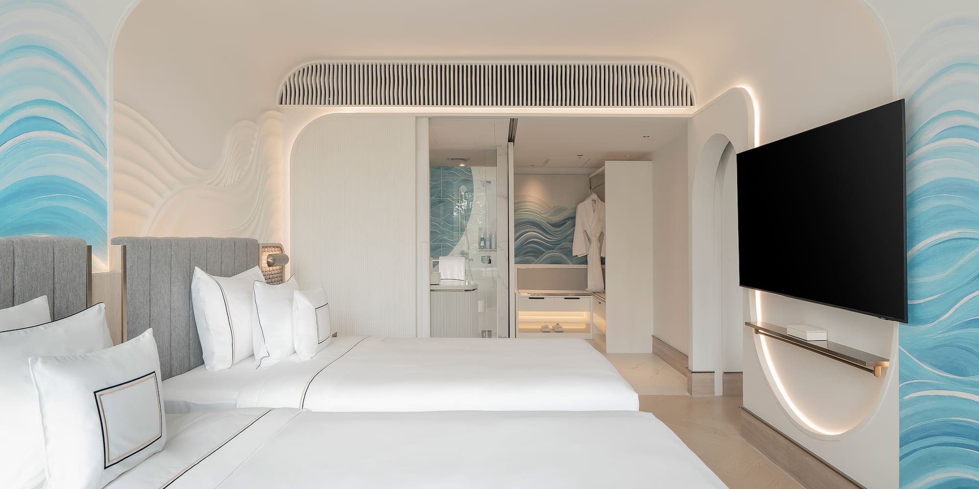 a room with two beds and a television