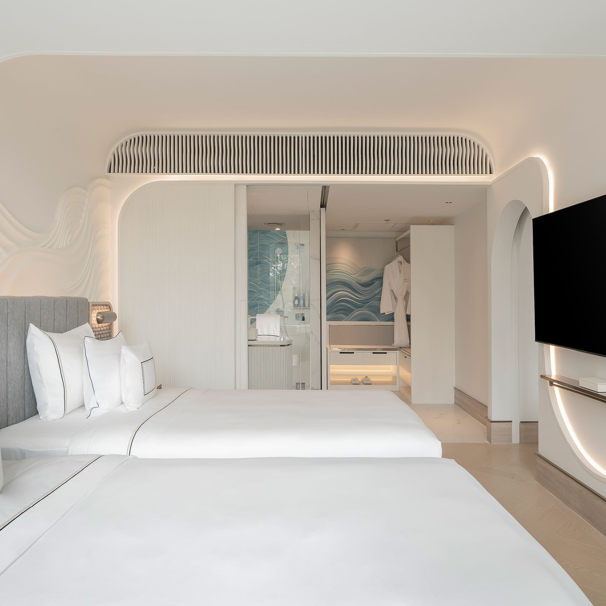 a room with two beds and a television