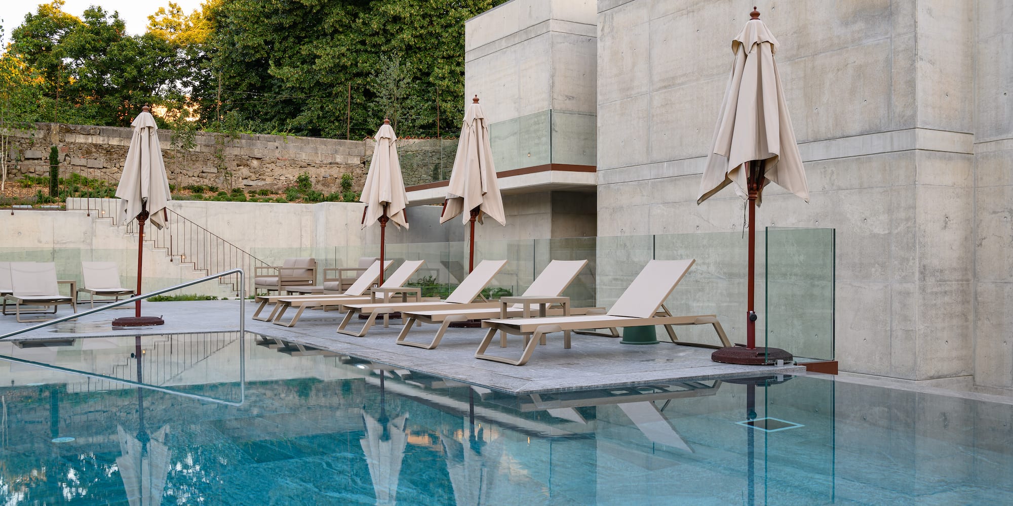 a pool with lounge chairs and umbrellas