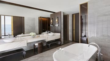 a bathroom with a large tub and sink