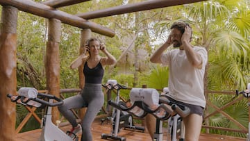 a man and woman on exercise bikes