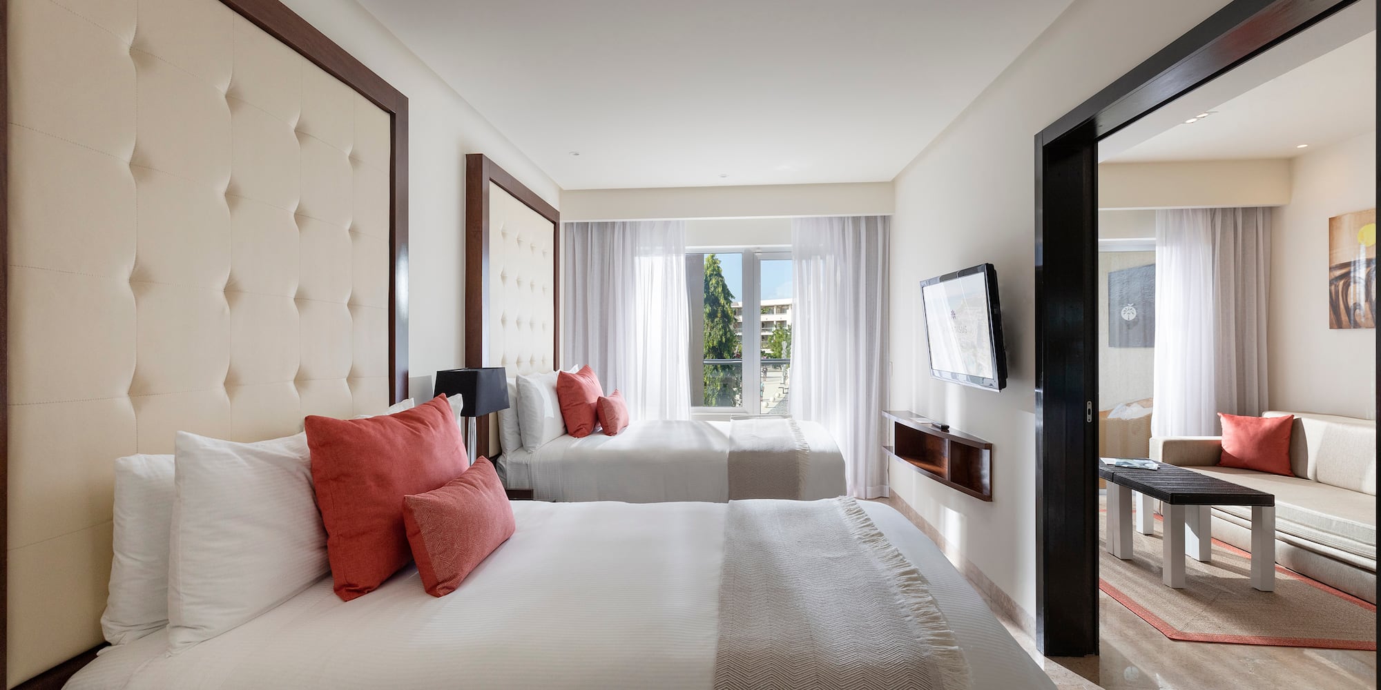 a room with two beds and a television