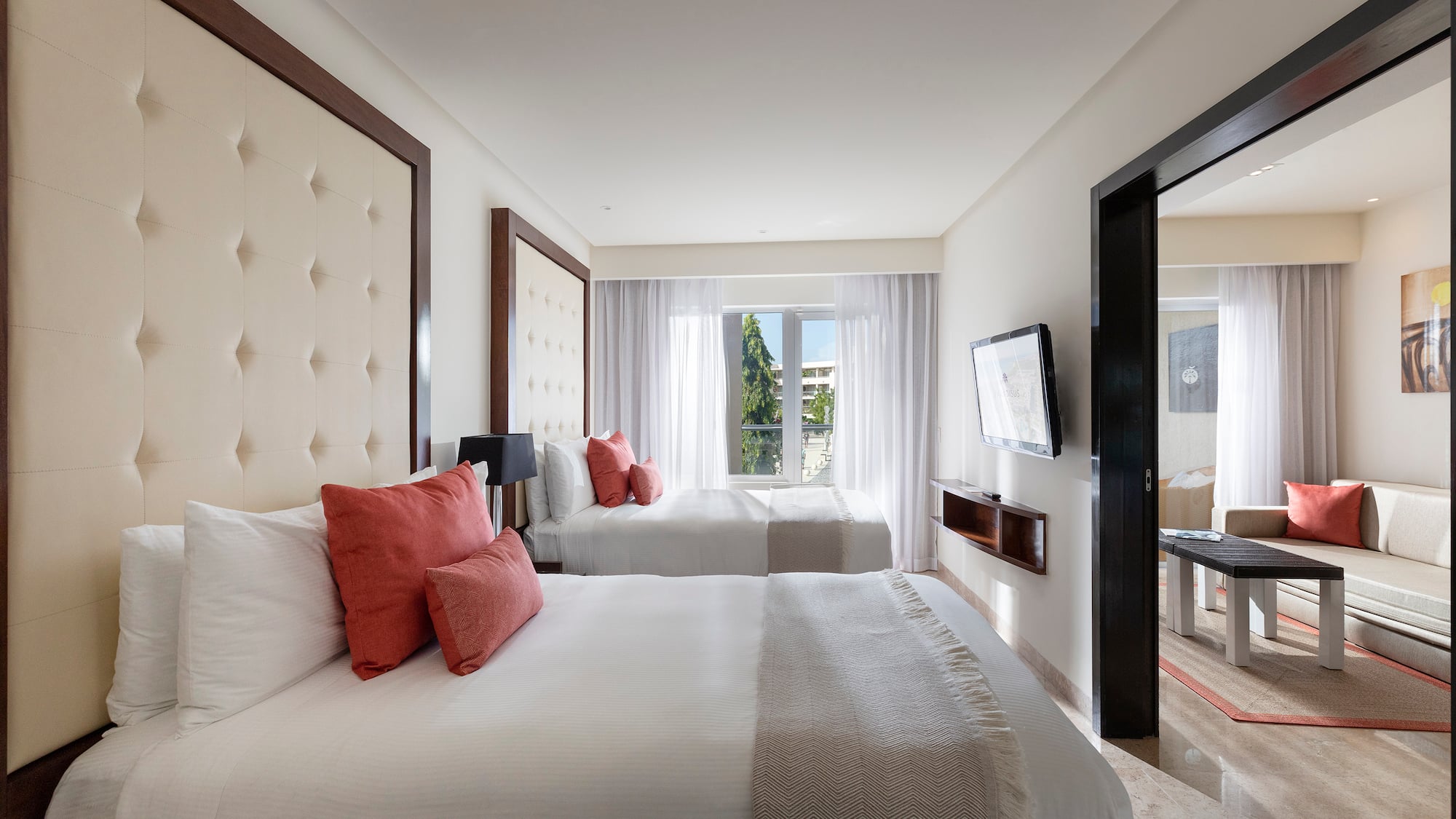 a room with two beds and a television